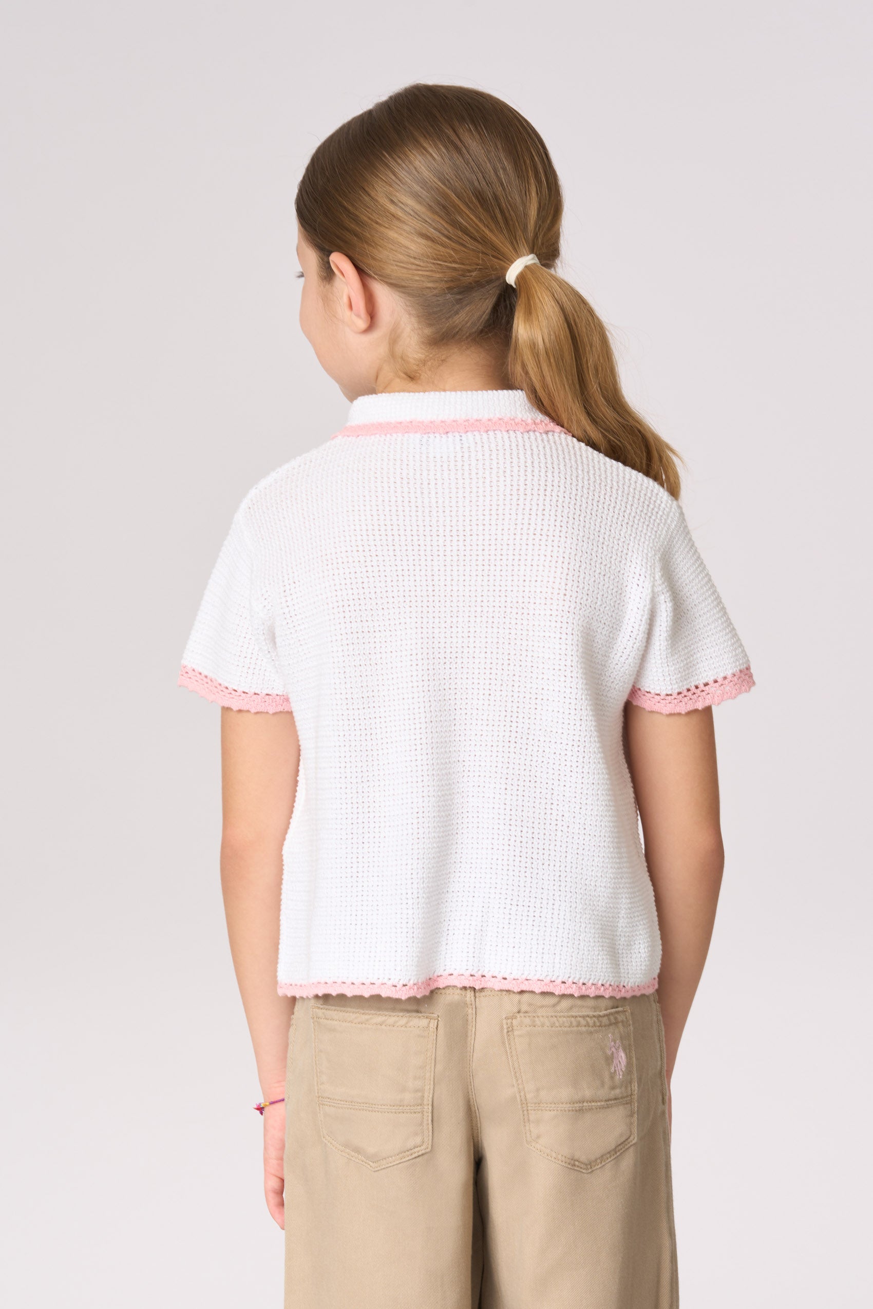 Polo shirt da bambina in maglia con lavorazione crochet